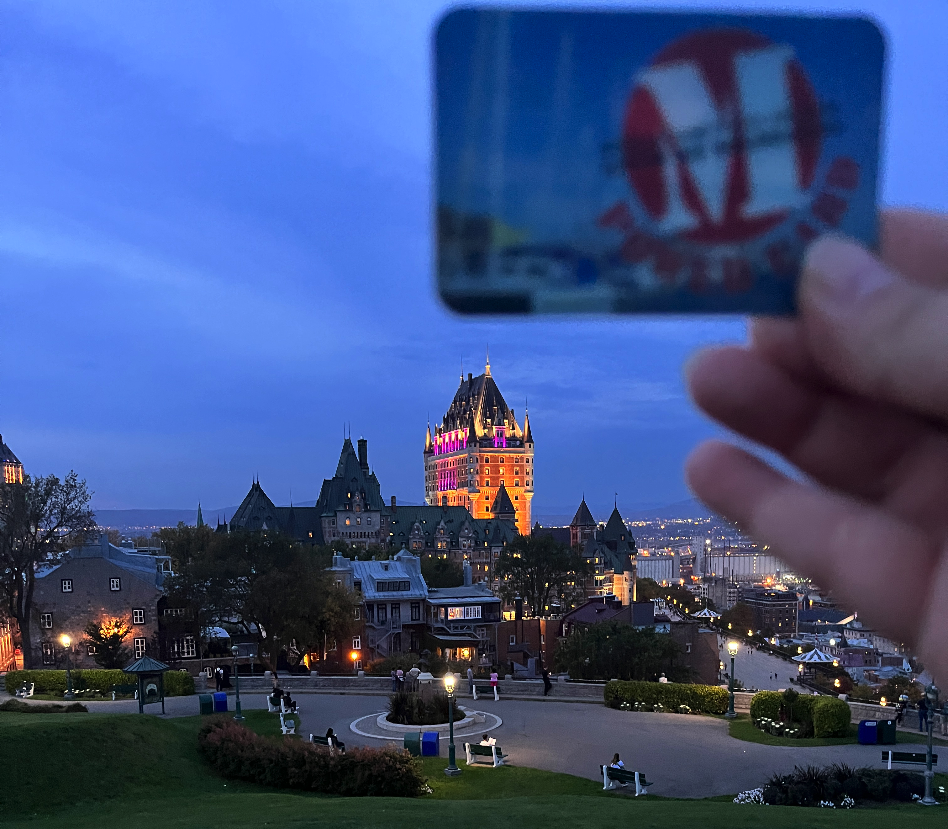 Anne Arundel County Library card shown in the foreground of an early evening photo overlooking Quebec City