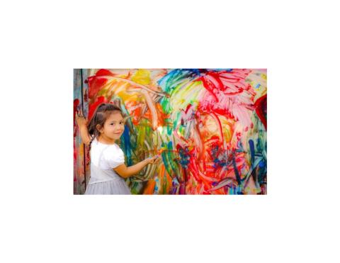 Small child with a messy, colorful painting